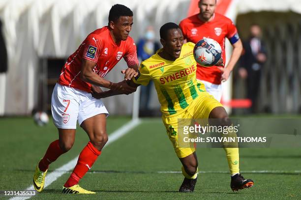 Nimes' Swedish midfielder Niclas Eliasson vies for the ball with Nantes' Malian defender Charles Traore during the French L1 football match between...