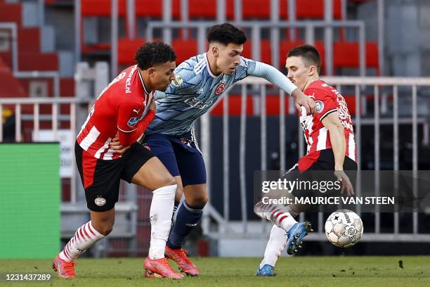 Donyell Malen of PSV Eindhoven, Lisandro Martinez of Ajax, Ryan Thomas of PSV Eindhoven fight for the ball during the Dutch Eredivisie match between...