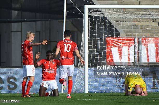 Nimes' Senegalese forward Moussa Kone celebrates after scoring a goal during the French L1 football match between Nimes Olympique and FC Nantes at...