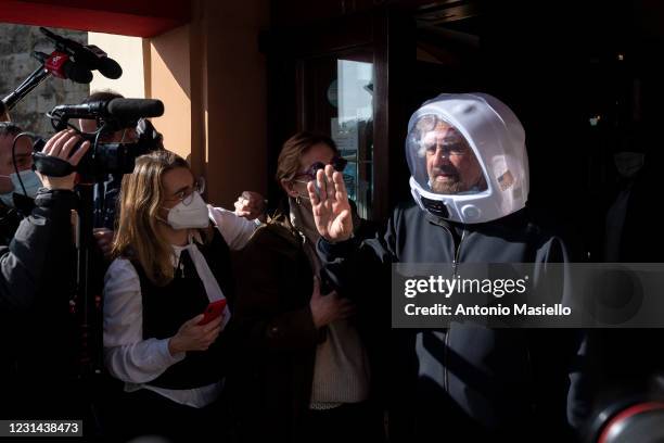 Beppe Grillo, co-founder of the 5-Stars Movement wearing an astronaut helmet, leaves the Hotel Forum following a meeting to decide the leadership of...