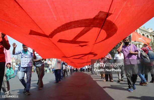 Supporters walks to attend a joint mass meeting in a mega rally ahead of the 2021 state legislative assembly elections in Kolkata , India on Sunday,...