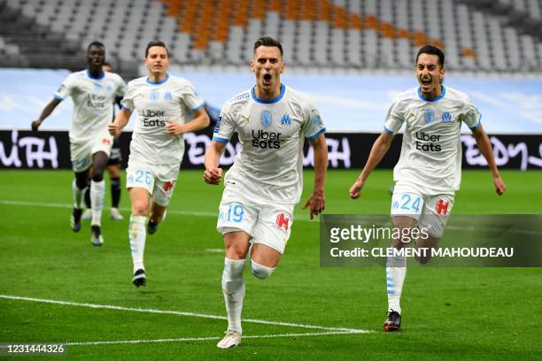 Marseille's Polish forward Arkadiusz Milik celebrates after scoring a goal during the French L1 football match between Olympique de Marseille and...