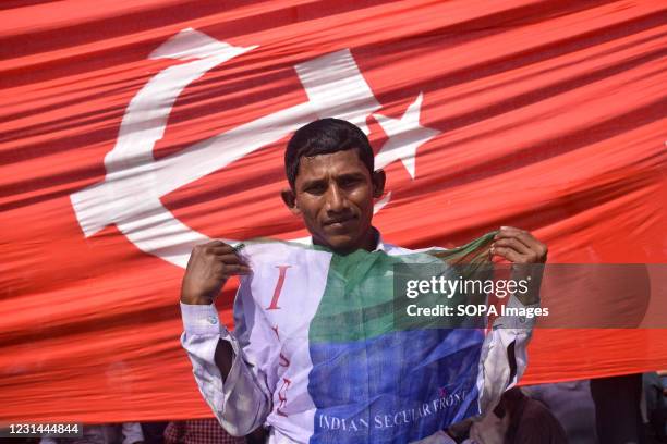 Supporter holds a flag during the mega rally. The Communist party CPIM launches a mega rally with its allies the Congress and The Indian Secular...