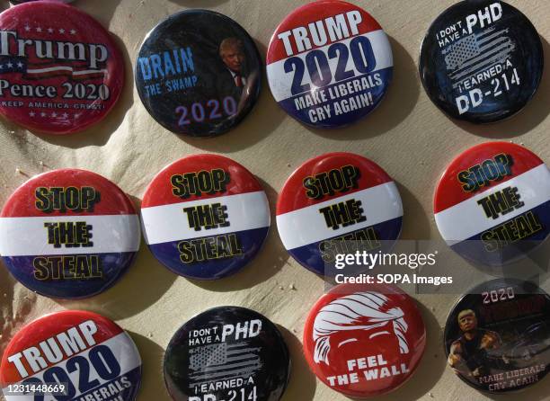 Badges saying "Stop the Steal" are seen for sale outside the 2021 Conservative Political Action Conference at the Hyatt Regency where former...