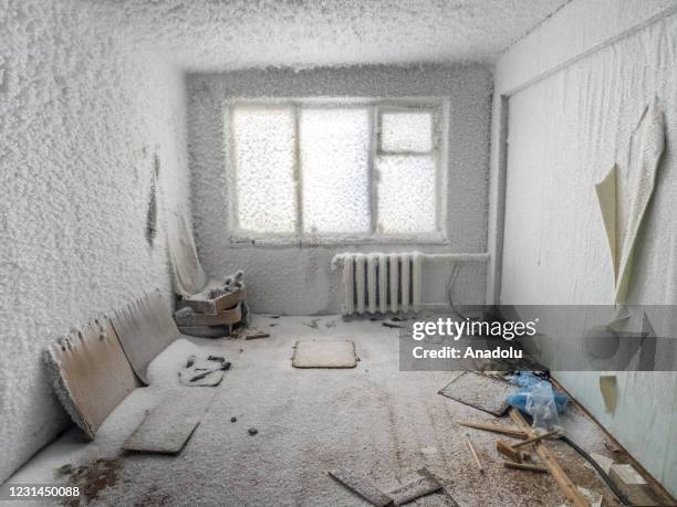 An inside view from snow and ice covered abandoned building in Sementnozavodsky region, 19 kilometers from coal-mining town Vorkuta, Komi Republic,...