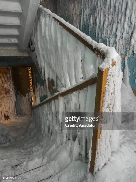 An inside view from snow and ice covered abandoned building in Severny region, 17 kilometers from coal-mining town Vorkuta, Komi Republic, Russia on...