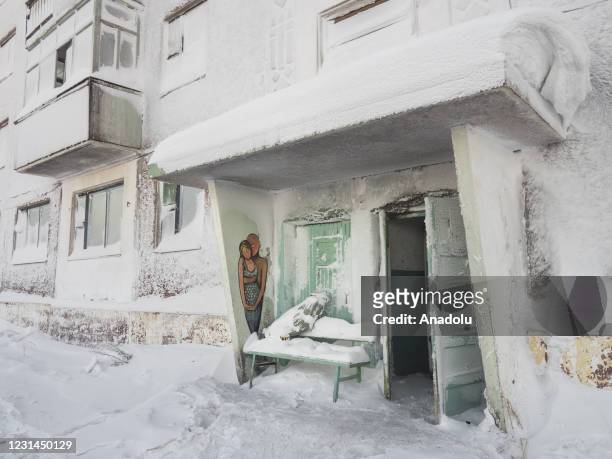 View of snow and ice covered abandoned buildings in Sementnozavodsky region, 19 kilometers from coal-mining town Vorkuta, Komi Republic, Russia on...