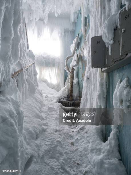 An inside view from snow and ice covered abandoned building in Severny region, 17 kilometers from coal-mining town Vorkuta, Komi Republic, Russia on...