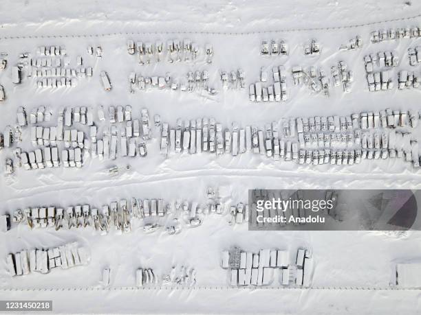 An aerial view shows snow and ice covered heavy equipment that have been parked for a long time at a construction site in coal-mining town Vorkuta,...