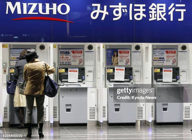 Mizuho Bank ATM services are seen out of service in Tokyo on March 1 due to a glitch affecting cash withdrawals and other transactions. Some ATMs of...