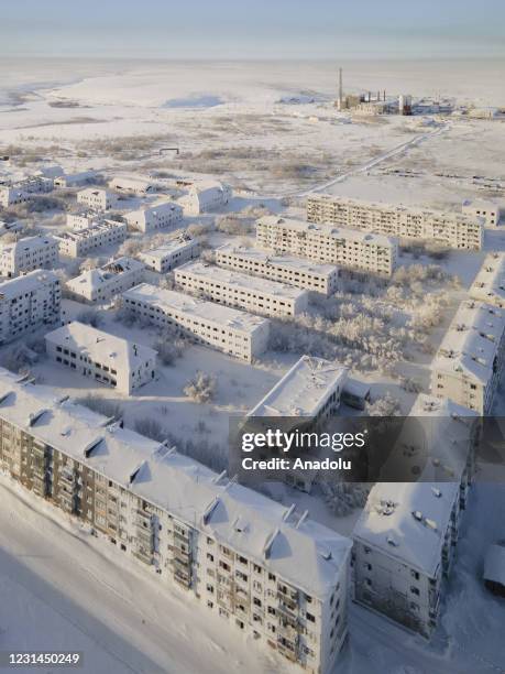 View of snow and ice covered abandoned buildings in Sementnozavodsky region, 19 kilometers from coal-mining town Vorkuta, Komi Republic, Russia on...