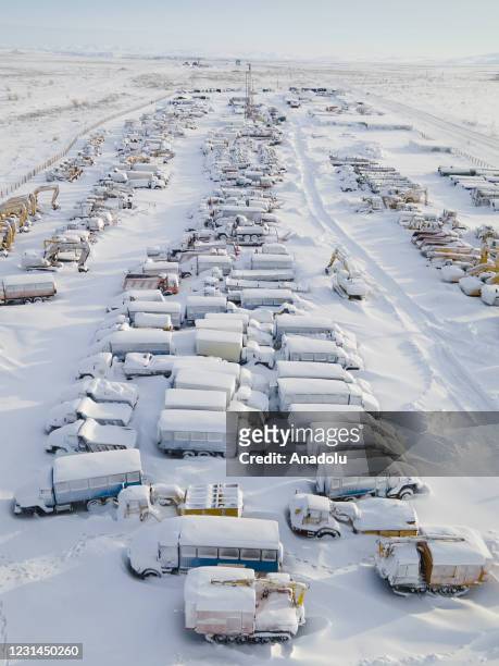 An aerial view shows snow and ice covered heavy equipment that have been parked for a long time at a construction site in coal-mining town Vorkuta,...