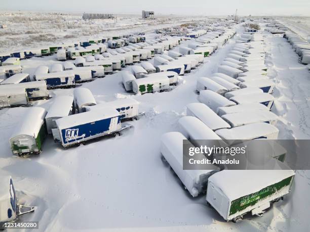 An aerial view shows snow and ice covered heavy equipment that have been parked for a long time at a construction site in coal-mining town Vorkuta,...