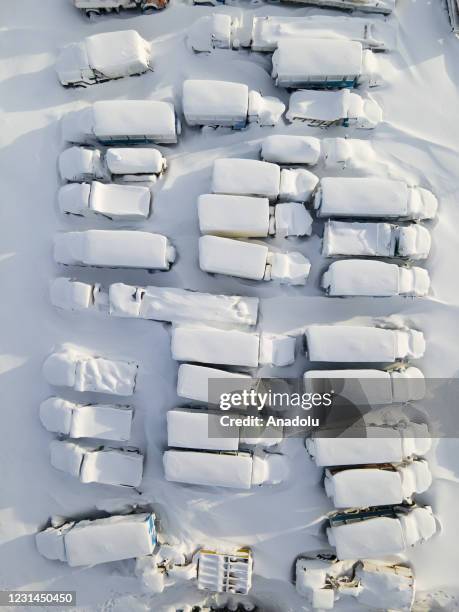 An aerial view shows snow and ice covered heavy equipment that have been parked for a long time at a construction site in coal-mining town Vorkuta,...