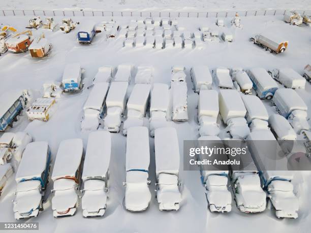 An aerial view shows snow and ice covered heavy equipment that have been parked for a long time at a construction site in coal-mining town Vorkuta,...