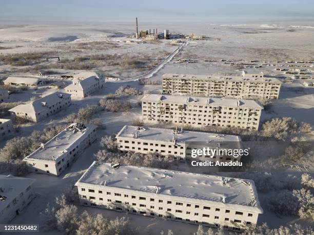 View of snow and ice covered abandoned buildings in Sementnozavodsky region, 19 kilometers from coal-mining town Vorkuta, Komi Republic, Russia on...