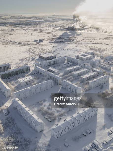 View of snow and ice covered abandoned buildings in Sementnozavodsky region, 19 kilometers from coal-mining town Vorkuta, Komi Republic, Russia on...
