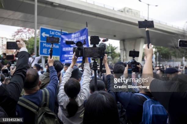 Members of the media film outside the West Kowloon Magistrates Courts during a hearing for 47 opposition activists charged with violating the citys...