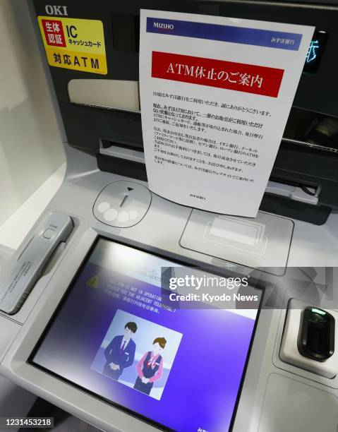 Mizuho Bank ATM is seen out of service in Tokyo on March 1 due to a glitch affecting cash withdrawals and other transactions. Some ATMs of the major...