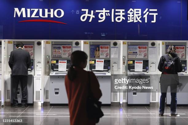 Some Mizuho Bank ATMs are seen out of service in Tokyo on March 1 due to a glitch affecting cash withdrawals and other transactions. Some ATMs of the...