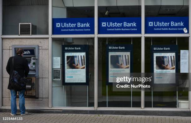 Man uses an Ulster Bank ATM in Dublin city center during Level 5 COVID-19 lockdown. The Bank of Ireland announced today the closure of 103 branches...