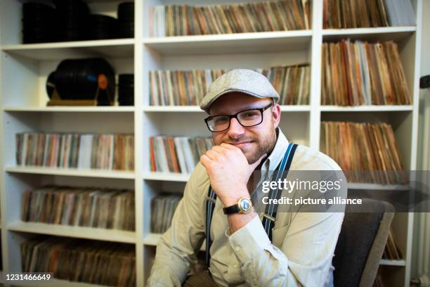 February 2021, North Rhine-Westphalia, Datteln: Kevin Nikodem in front of part of his record collection in his home. Nikodem lives like he did in the...