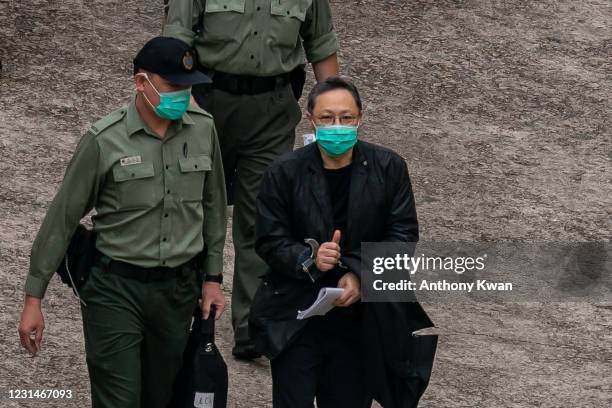 Hong Kong pro-democracy activist Benny Tai makes a gesture as he prepares to board a Correctional Service Department van at Lai Chi Kok Reception...