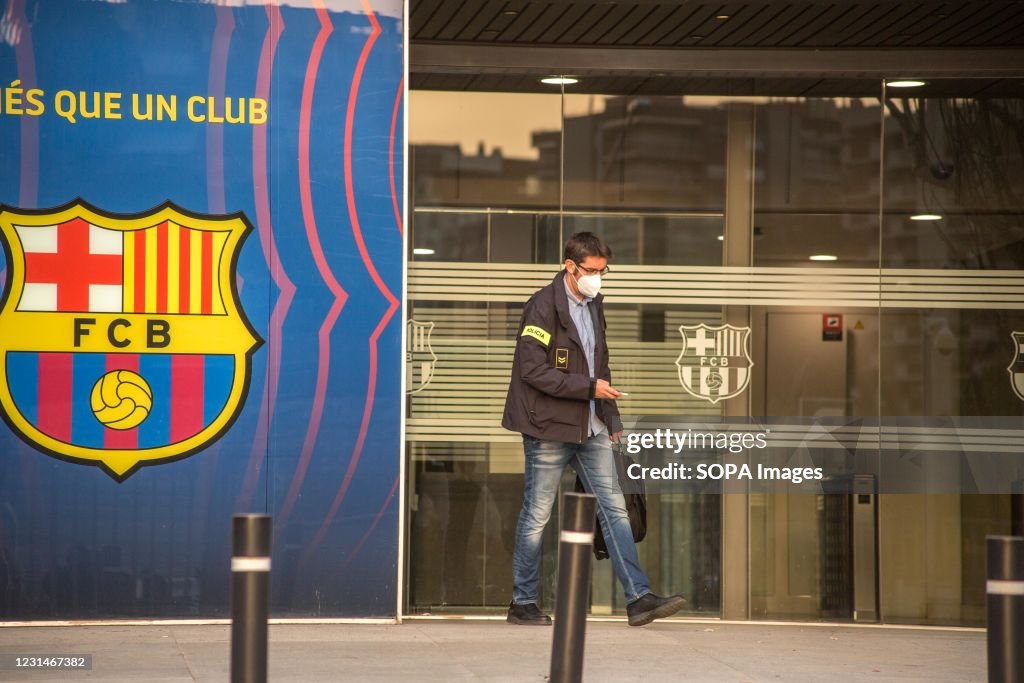 A police officer seen leaving the FC Barcelona office.