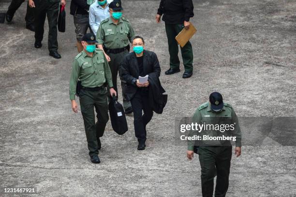 Benny Tai, a pro-democracy activist, walks towards a Correctional Services Department vehicle at the Lai Chi Kok Reception Center to be transported...