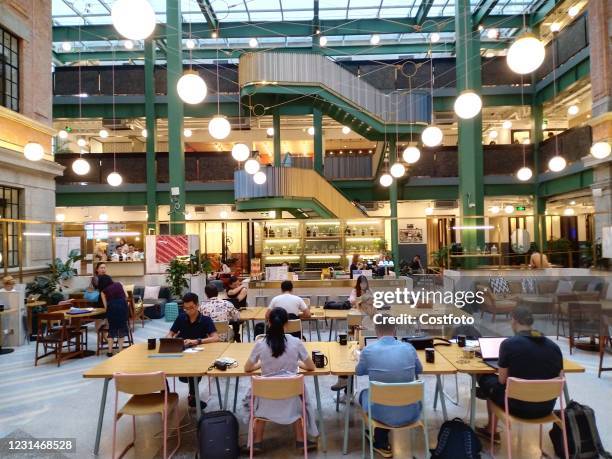 Employees work at a WeWork office in Shanghai, China, Aug. 13, 2019. WeWork founder Mark Neumann and his committee have reached a $1.6 billion...