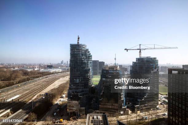 Construction cranes at the Valley residential apartment and office property beside the A10 highway in the Zuidas business district in Amsterdam,...