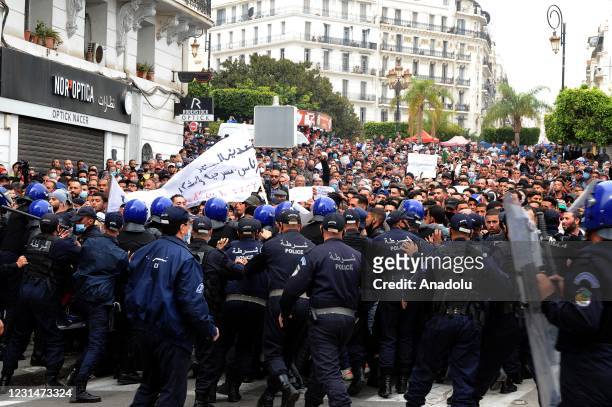 Police officers block the road as Algerian anti-government protesters take the streets of the capital Algiers within "Hirak" pro-democracy movement...