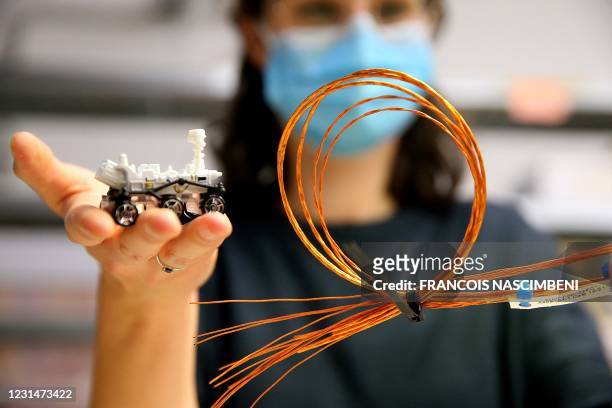An employee of Axon'Cable, specialist in custom-designed interconnect, shows cables made for the aeronautics and aerospatial sectors at the company's...