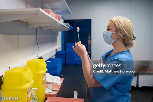 Health worker prepares the AstraZeneca Covid-19 vaccine at a mass vaccination centre at Holm View Leisure Centre on March 2, 2021 in Barry, Wales....