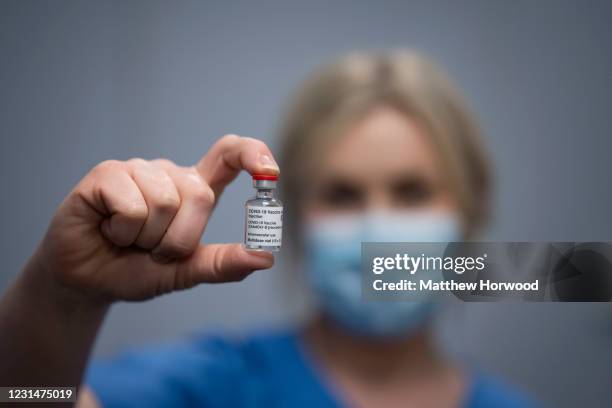 Health worker holds up the AstraZeneca Covid-19 vaccine at a mass vaccination centre at Holm View Leisure Centre on March 2, 2021 in Barry, Wales....