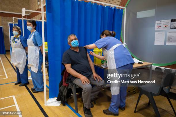 Health worker administers the AstraZeneca Covid-19 vaccine to a man at a mass vaccination centre at Holm View Leisure Centre on March 2, 2021 in...