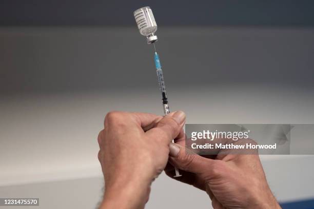 Health worker prepares the AstraZeneca Covid-19 vaccine vaccine at a mass vaccination centre at Holm View Leisure Centre on March 2, 2021 in Barry,...