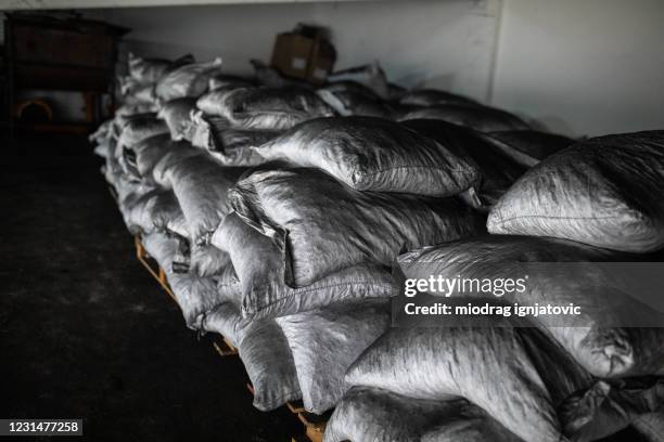 sacks full of coconut charcoal for hookah in warehouse of factory - briquettes stock pictures, royalty-free photos & images