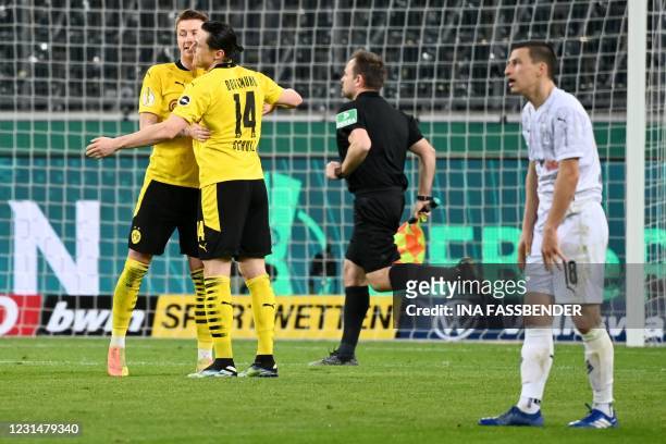 Dortmund's German forward Marco Reus celebrates the team's win with Dortmund's German defender Nico Schulz next to Moenchengladbach's Austrian...