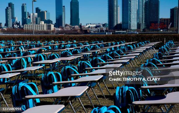 School desks are setup as part of a UNICEF 'Pandemic Classroom',each seat representing one million children living in countries where schools have...