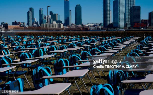 School desks are setup as part of a UNICEF 'Pandemic Classroom',each seat representing one million children living in countries where schools have...