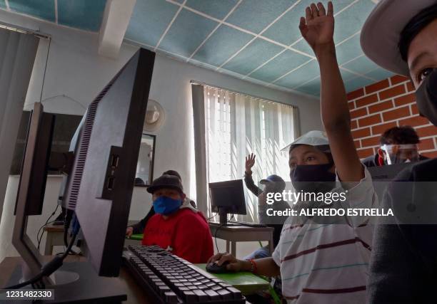 Children attend a computer science class at the Escalerillas neighborhood in Chimalhuacan, Mexico state, Mexico, on February 24, 2021. - The COVID-19...