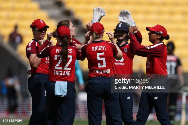 England celebrate New Zealand's captain Sophie Devine being caught during the third women's Twenty20 cricket match between New Zealand and England in...