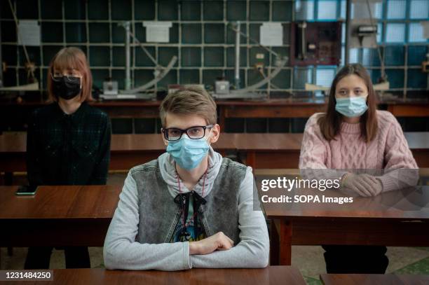 High school students wearing face masks attend a chemistry class at the School of Additional Education in Tambov. Many schools in Russia now conduct...