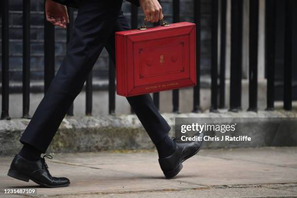 Chancellor Of The Exchequer, Rishi Sunak carries the red box as he walks outside 11 Downing Street ahead of the Chancellor of the Exchequer's...