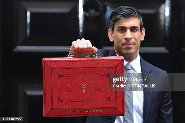 Britain's Chancellor of the Exchequer Rishi Sunak poses with the Budget Box as he leaves 11 Downing Street before presenting the government's annual...