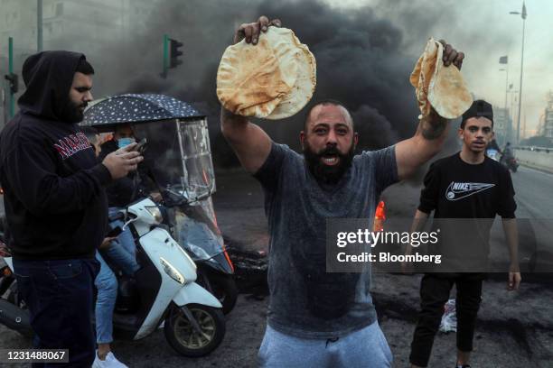 Demonstrator holds government subsidized bread during a protest in Beirut, Lebanon, on Tuesday, March 2, 2021. Lebanon's annual inflation rate...