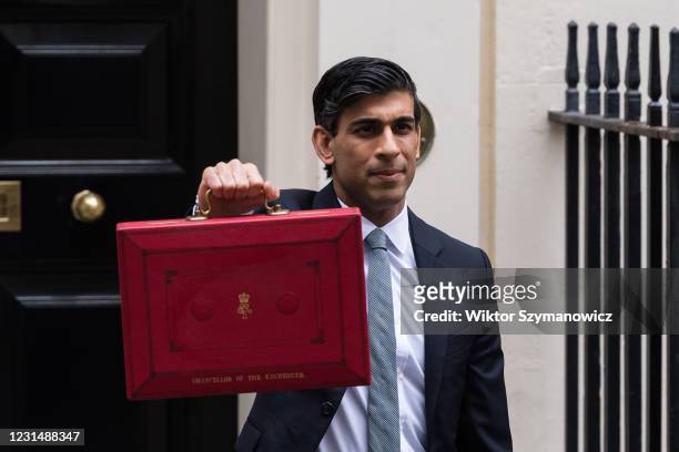 Chancellor of the Exchequer Rishi Sunak holds the Budget box outside 11 Downing Street in central London ahead of the announcement of the Spring...