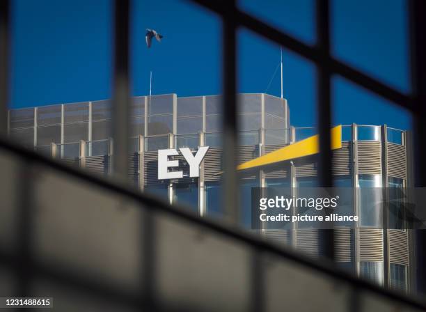 February 2021, Berlin: The logo of the auditing and consulting firm Ernst & Young is attached to the top floor of the high-rise building in the...