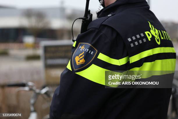 Picture shows a Dutch police badge on an officer's uniform during an investigation after an explosion at a Covid-19 testing centre in the town of...